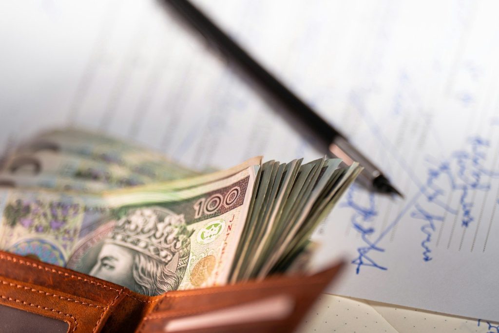 Stack of polish zloty banknotes in a wallet.
